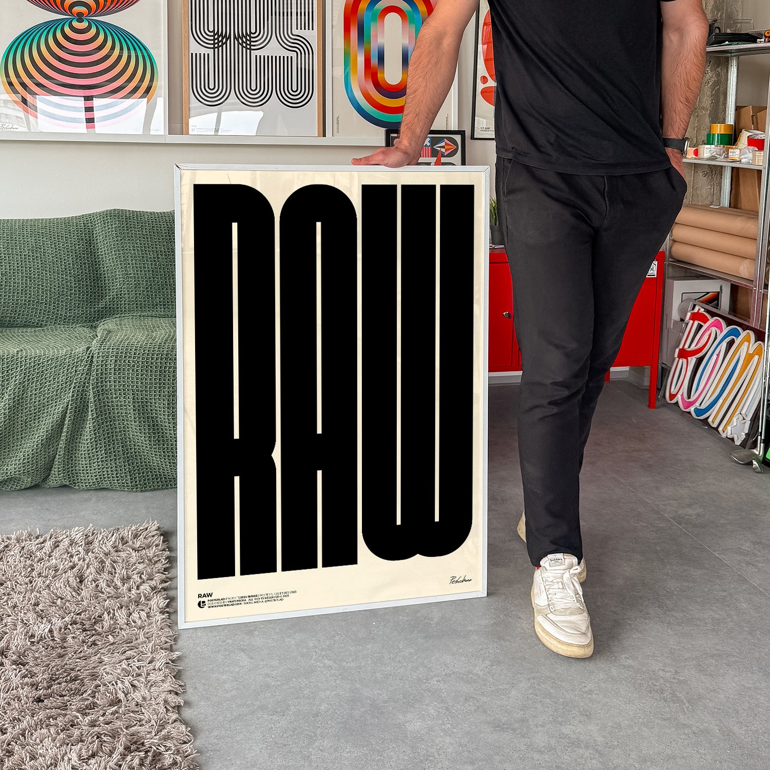 Bold black RAW poster featuring oversized, all-caps typography on a light cream background